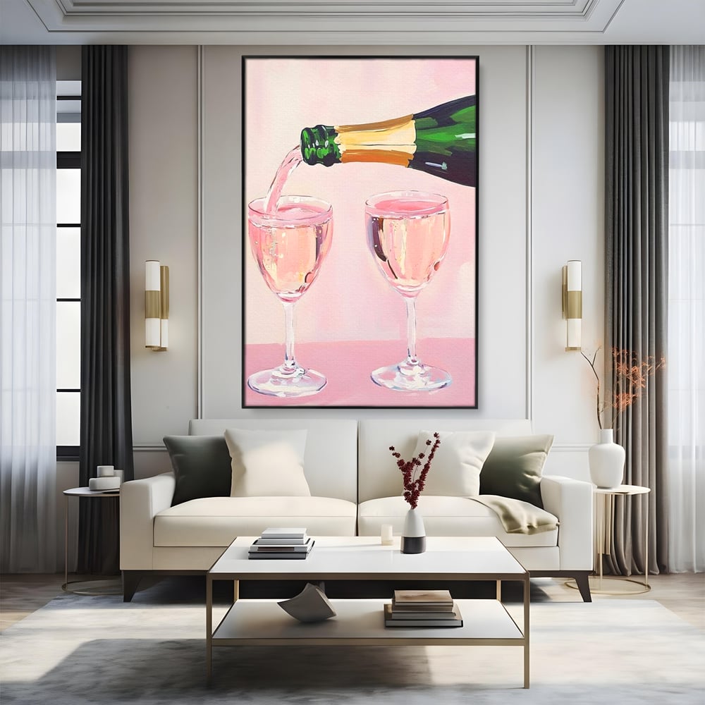 Tablou canvas cu pictura cu sticla si pahare de sampanie roz, in rama de aluminiu negru, pe perete intr-un living